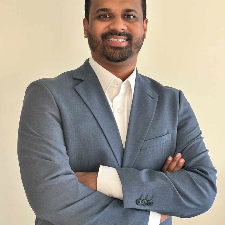 Joseph, Dubai real estate advisor, smiling with arms crossed